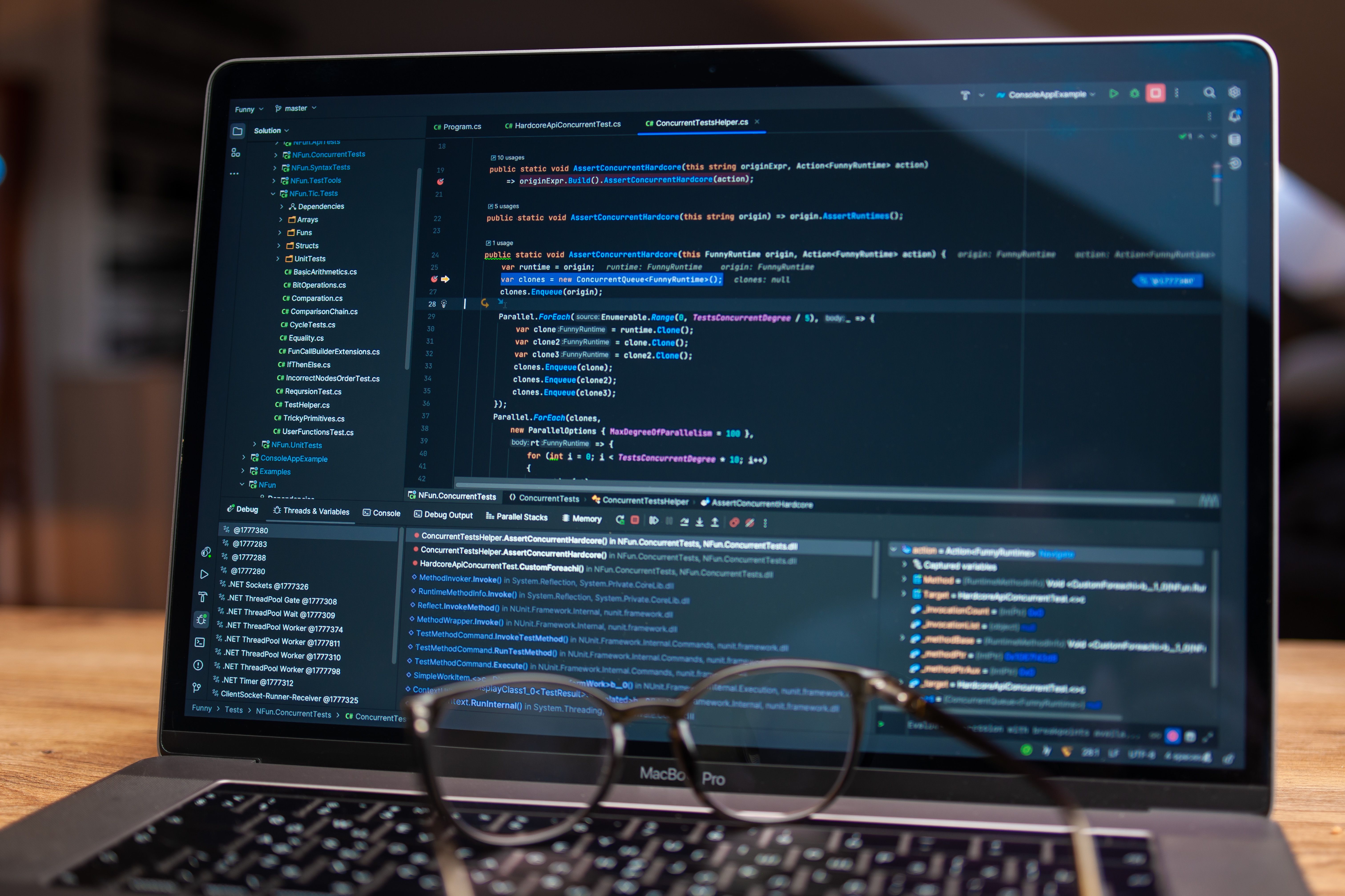 Laptop displaying debugging software and code during a software testing session.